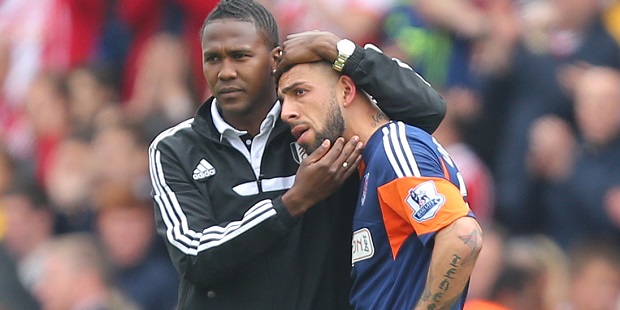 Ashkan Dejagah is consoled by Fulham team-mate Hugo Rodallega