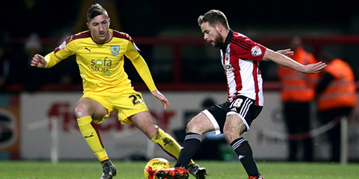 Burnley's Stephen Ward and Brentford's Alan Judge (right) battle for the ball