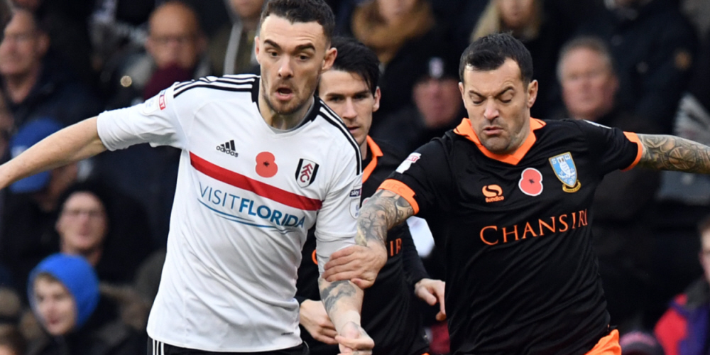 Fulham's Scott Malone battles with Sheffield Wednesday's Ross Wallace during the Sky Bet Championship match at Craven Cottage, London.