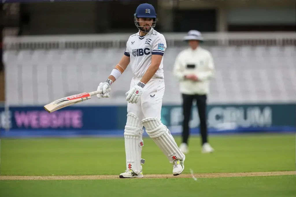 Holden helps Middlesex battle to draw